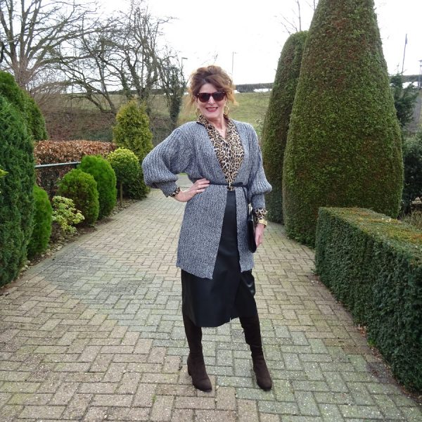 outfit with leather skirt, grey cardigan and leopard print blouse