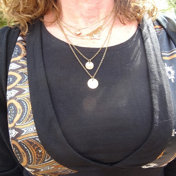 wearing several necklaces