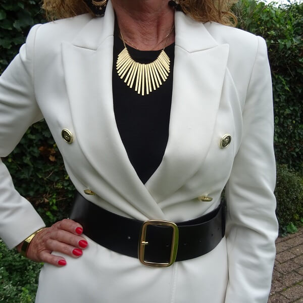 golden necklace on black and white