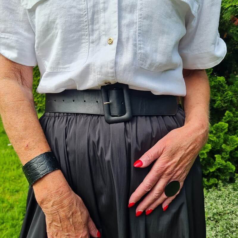 black bracelet and black statement ring