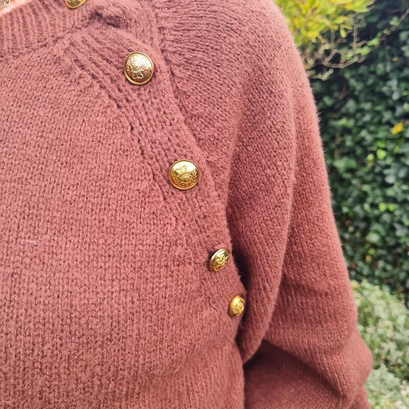 brown jumper with golden buttons