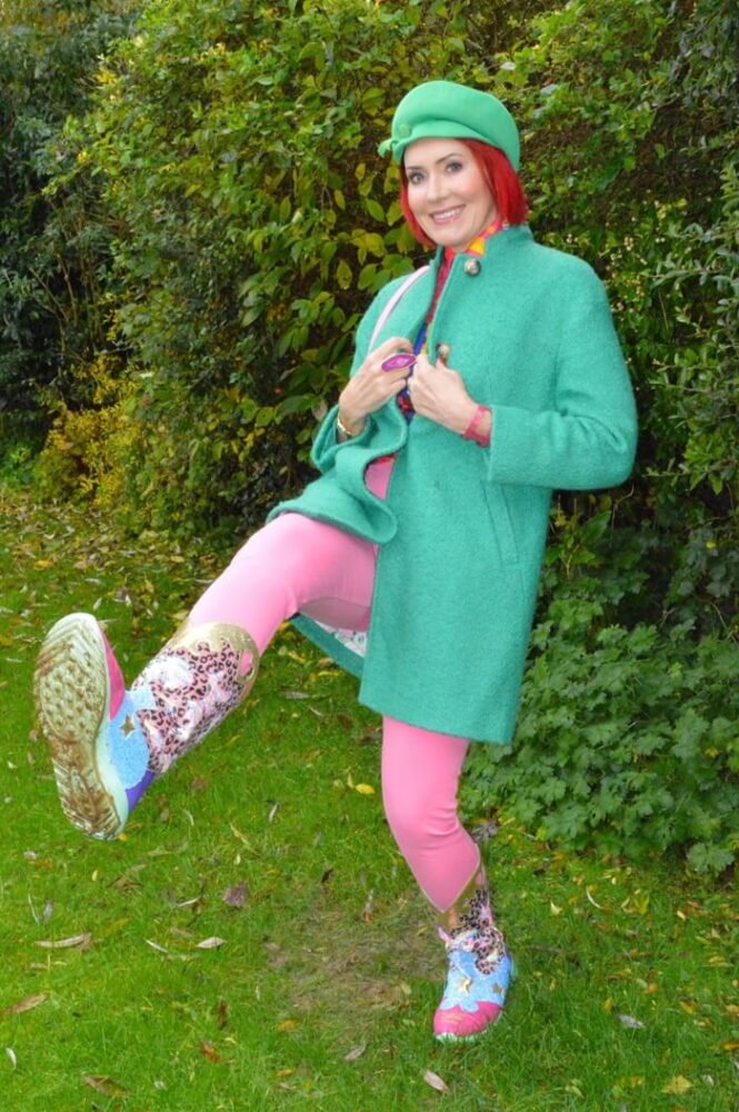 green coat and pink trousers