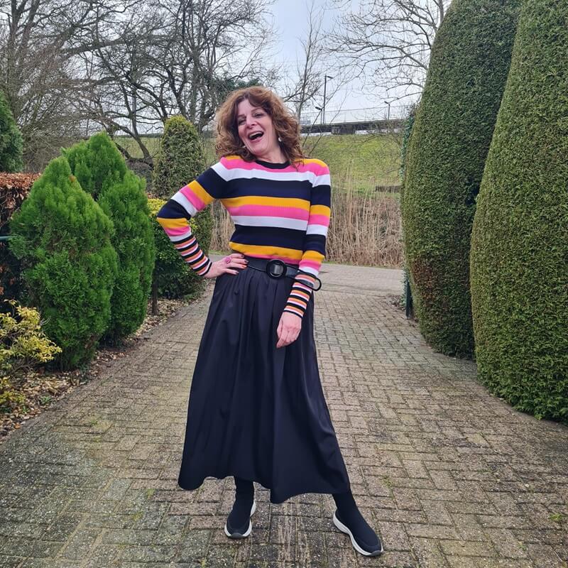striped jumper and a black skirt with pockets