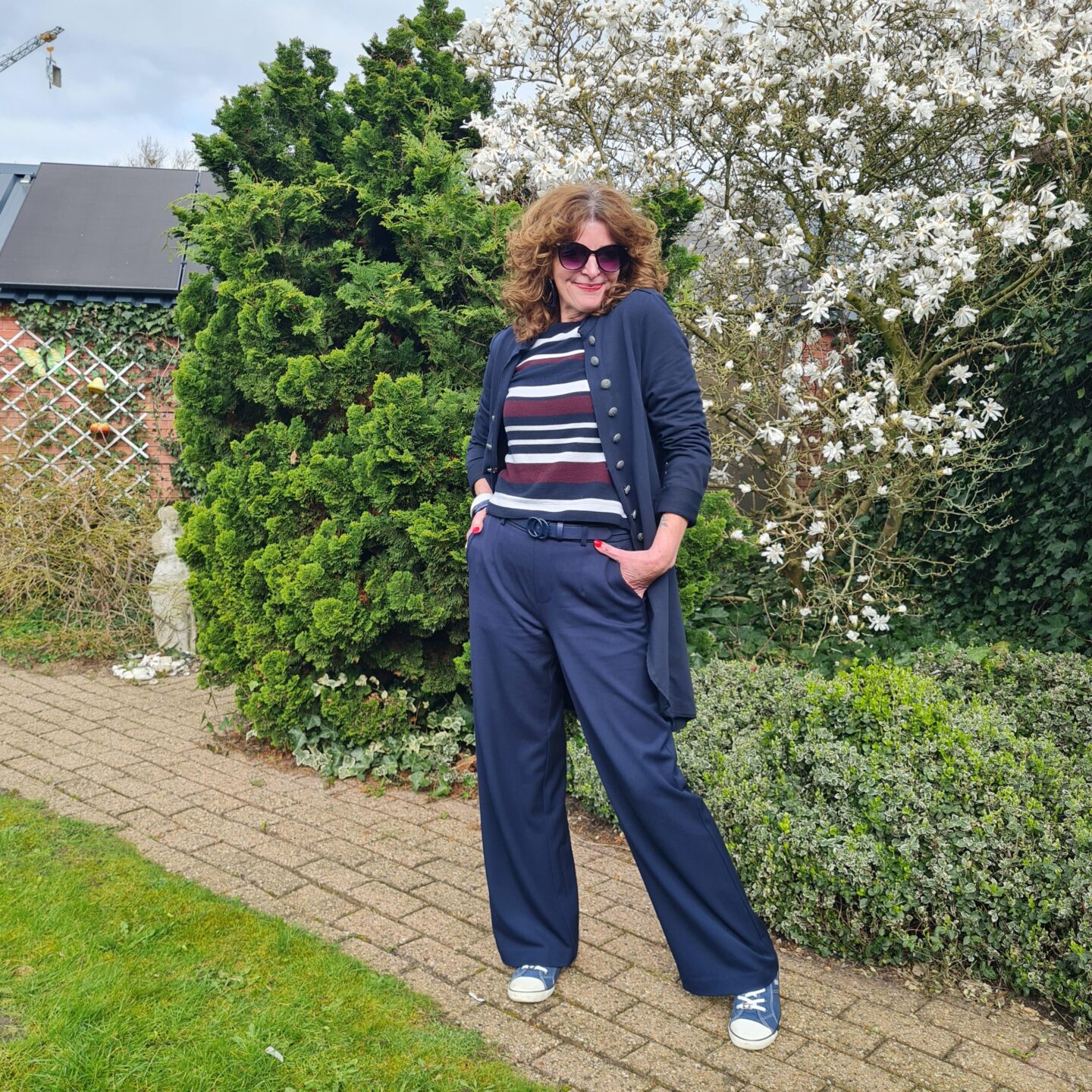 white sneakers under wide legged trousers