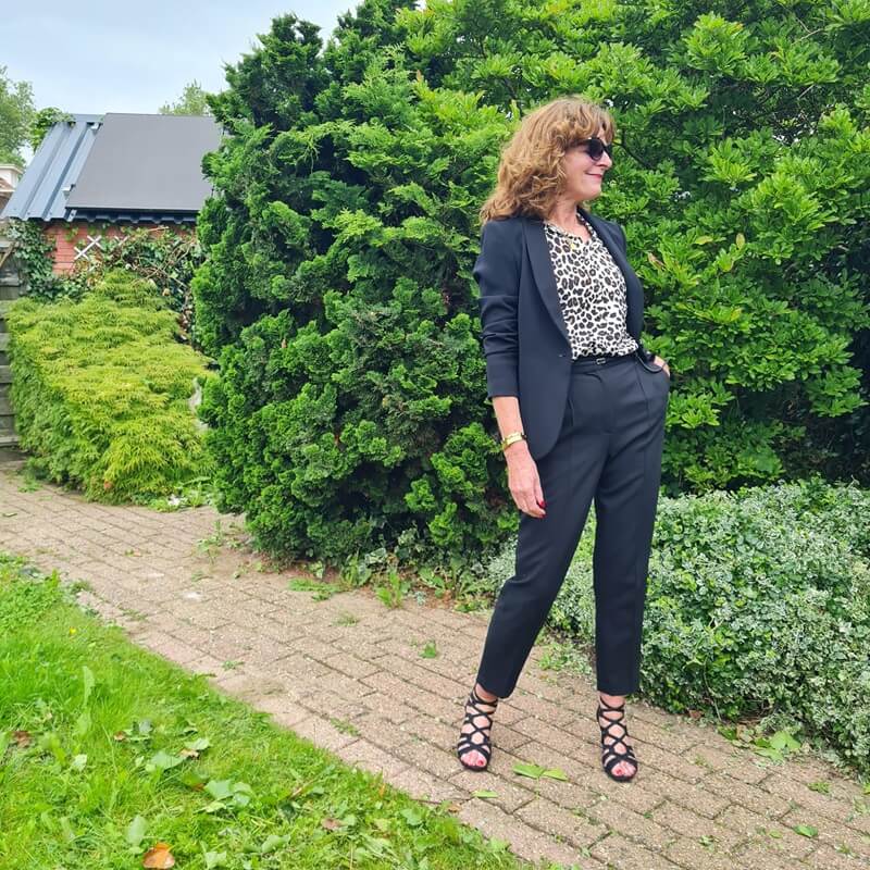 outfit with black trousers and blazer and printed blouse