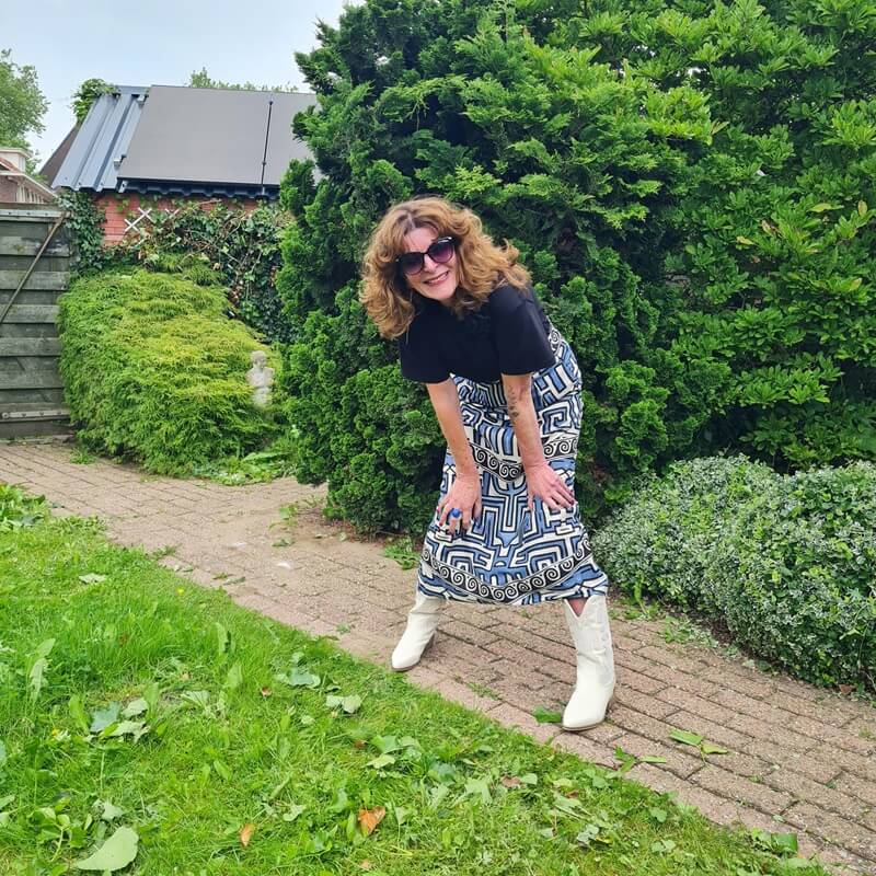 black tee with a floral pin