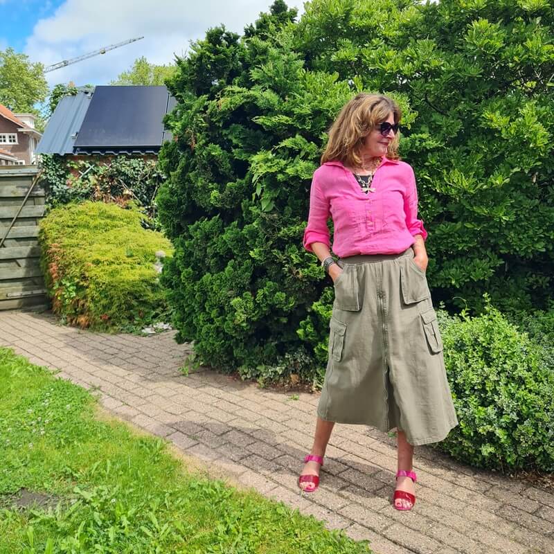 pink sandals under a green skirt