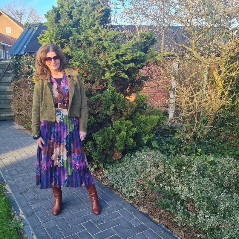 purple pleated dress with green cardigan