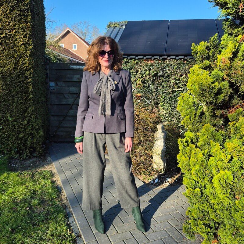 grey blazer with green bracelets