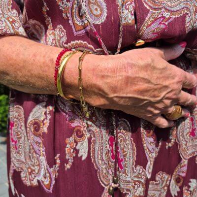 golden bracelets and a burgundy beaded one