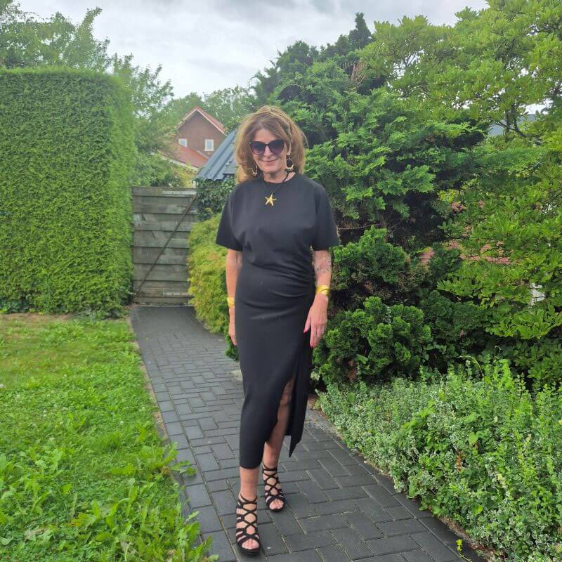 black dress with golden accessories
