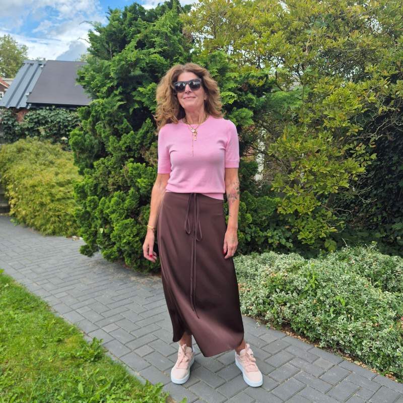 rich brown silky skirt and a soft pink knit top